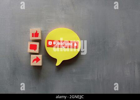 Technology and media social concept. Top view of wooden cubes with text SUBSCRIBE and like, comment and share icon. Stock Photo