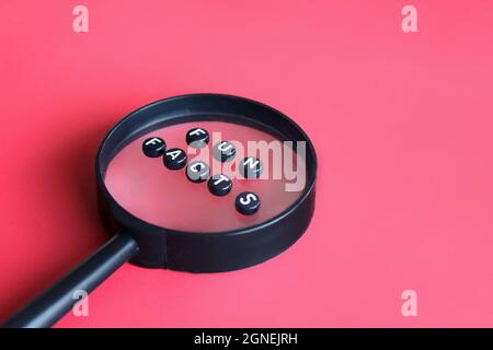 Magnifying glass and alphabet beads with text FUN FACTS Stock Photo