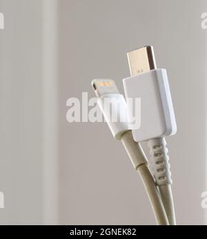 VLADIVOSTOK, RUSSIA - SEPTEMBER 24, 2021: Apple Lightning Connector and USB Type-C cables. Selective focus. Stock Photo