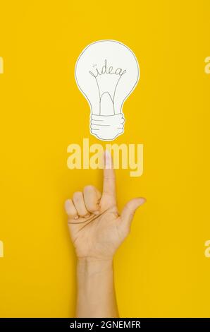 hand pointing lighten bulb. High quality and resolution beautiful photo concept Stock Photo