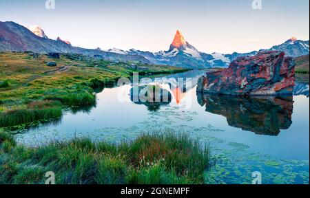 Impressive summer scene of the Stellisee lake. Splendid evening view of Matterhorn (Monte Cervino, Mont Cervin) in Swiss Alps, Switzerland, Europe. Be Stock Photo
