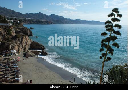 Nerja  Spain  September 22 2021 : Summer beach scene Landscape view of pristine sands Holiday makers enjoy the beautiful coast and blue sea Copy space Stock Photo