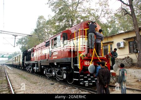 Florists decorates a luxury  train engine on its inaugural day at Safdarjung railway station in New Delhi. Stock Photo