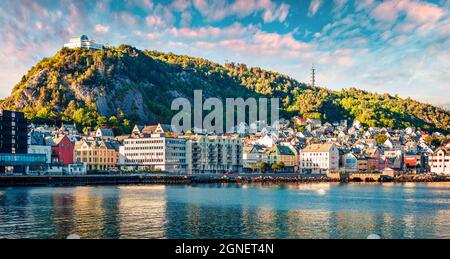 Beautiful summer view of Alesund port town on the west coast of Norway, at the entrance to the Geirangerfjord. Colorful sunset in the Nord. Traveling Stock Photo