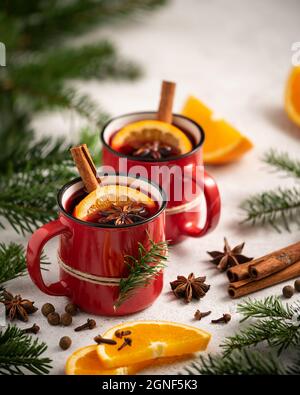 Christmas card with mulled wine, spices and oranges surrounded by fir branches Stock Photo