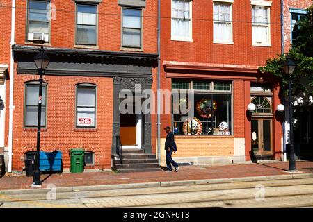 Afro American man walking past A.T. Jones & Sons costume shop, N Howard St, Baltimore, Maryland, USA Stock Photo