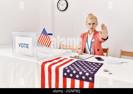 Beautiful caucasian woman working at political campaign doing stop sing with palm of the hand. warning expression with negative and serious gesture on Stock Photo