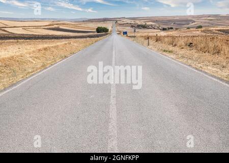 Perspective view of a country road in the middle of Sardinia in the summer Stock Photo