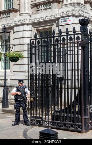 London, UK, July 1, 2012 : Number 10 Downing Street in Whitehall home of the British Prime Minister and government with an armed police officer on dut Stock Photo