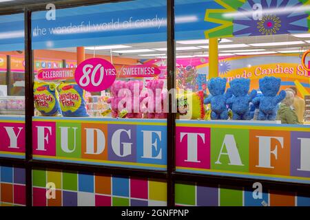 Colorful closeup of a Rehoboth Beach candy business window on the boardwalk.  Display features various candies and plush toys. Stock Photo