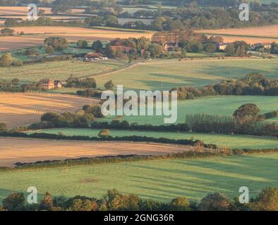 Stunning late Summer sunrise on South Downs National Park in English countryisde with vibrant sunlight on hills Stock Photo
