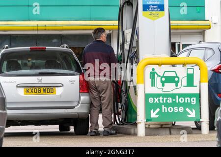 Bury St Edmunds, UK. 25th Sep, 2021. A man filling his car up during the fuel crisis in Bury St Edmunds.On 23rd September BP were forced to close a few of their service stations due to fuel shortages caused by a lack of lorry drivers. The news of fuel shortages soon caused a wave of panic buying across the UK with motorists queuing for hours to buy petrol and diesel. (Photo by Edward Crawford/SOPA Images/Sipa USA) Credit: Sipa USA/Alamy Live News Stock Photo