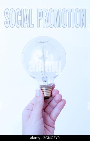 Writing displaying text Social Promotion, Conceptual photo advancing students to the next grade to be with their peers Hand holding lamp showing or pr Stock Photo