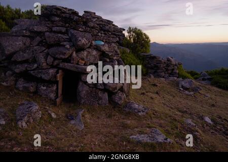 Cortelho, a small, rudimentar, stone-built shelter used by sheperds when herding cows in the highlands of the Soajo mountains. Stock Photo