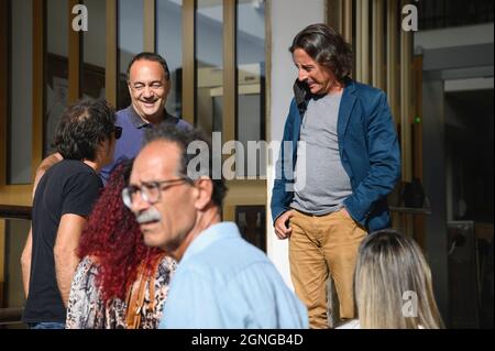 Locri, Italy. 25th Sep, 2021. Domenico Lucano (L) seen waiting outside the courthouse.The pro-migrant former Mayor of Riace, Domenico “Mimmo” Lucano, arrived at Locri's courthouse for the defensive conclusive statements of the trial for illegal immigration charges. The final session of the trial has been scheduled for September 27, 2021. Lucano is also running for upcoming regional elections with the list “Un'altra Calabria è possibile”. Credit: SOPA Images Limited/Alamy Live News Stock Photo