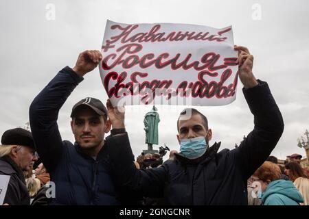 Moscow, Russia. 25th of September, 2021 Participants hold banners during an opposition rally to protest against the results of the Russian parliamentary election in Moscow, Russia. The banner reads 'Navalny + Russia = Freedom, Love!' Stock Photo