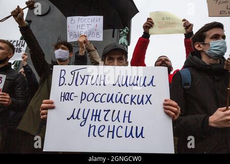 Moscow, Russia. 25th of September, 2021 Participants hold placards during an opposition rally to protest against the results of the Russian parliamentary election in Moscow, Russia. The main banner reads 'Putin deprived us - Russian men of a pension' Stock Photo