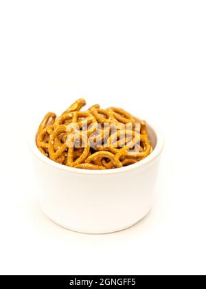 Salted mini pretzel snacks in white bowl isolated on white background Stock Photo