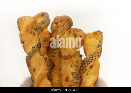 Closeup of bread sticks with cheese and poppy seeds isolated on white background Stock Photo