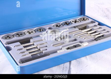 Tap and Die set in a bright blue tin isolated Stock Photo