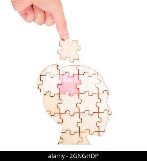 Placing the missing brain piece of the jigsaw puzzle forming a human ...