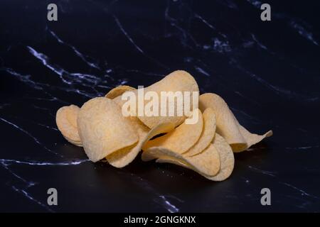 slices of potato chips close-up on a dark background close-up Stock Photo