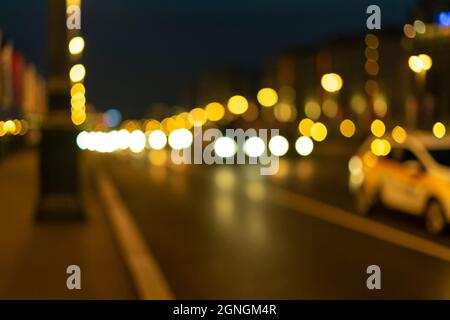 Colorful bokeh of city skyline from the sea in night time. Night bokeh light in big city Stock Photo