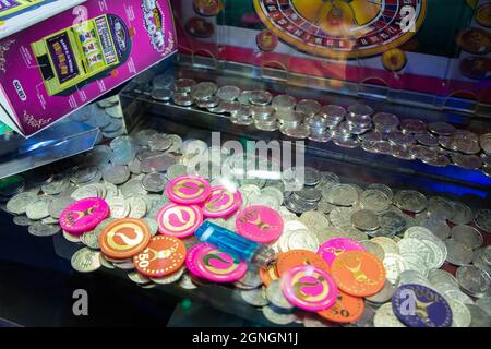 Coin pusher machine with a lot of coins Stock Photo
