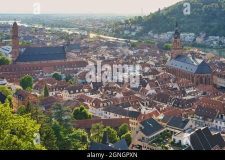 The Old Town of Heidelberg with the Church of the Holy Spirit and the Jesuit Church and river Neckar in the evening sun. View from the castle. Germany Stock Photo