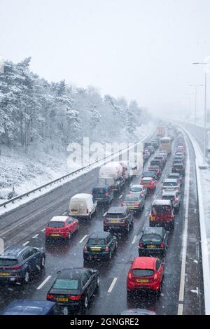 Exeter, UK - March 2018: Northbound traffic queueing on the M5 motorway during a cold, snowy day Stock Photo