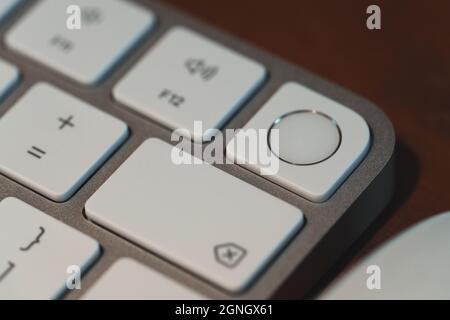 London, UK - May 25, 2021: Close up of Touch ID element on new Apple Magic keyboard introduced in 2021 alongside new iMac. Stock Photo