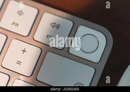 London, UK - May 25, 2021: Close up of Touch ID element on new Apple Magic keyboard introduced in 2021 alongside new iMac. Stock Photo
