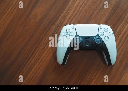 London, UK - May 25, 2021: Top view of Playstation 5 (PS5) controller on a table. Playstation 5 is the latest video game console by Sony released in N Stock Photo