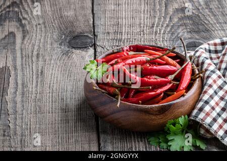 red spicy  marinated pepper in wooden bowl on the rustic table Stock Photo