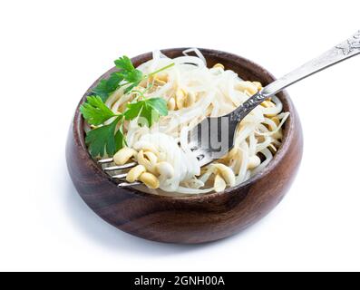 Marinated  sprouted mung beans in wooden bowl isolated on white