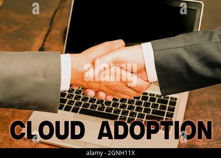 Text sign showing Cloud Adoption. Business overview strategic move by organisations of reducing cost and risk Two Professional Well-Dressed Corporate Stock Photo