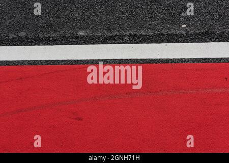 Asphalt decorated with a white line and a red field Stock Photo