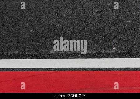 Asphalt decorated with a white line and a red field Stock Photo