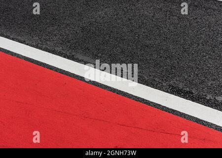 Asphalt decorated with a white line and a red field Stock Photo