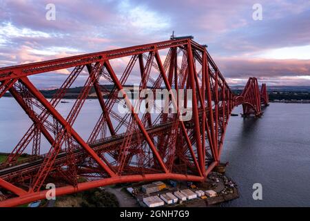 South Queensferry, Eaglesham, Scotland, UK. 25th Sep, 2021. PICTURED: Forth Rail Bridge, which is a national monument in its own right seen wearing its famous red lead paint which is needed to protect the structure from rusting from the elements. The bridge is painted by a team of painters, and when they finish they then start all over again. The bridge transports ScotRail train services from the east coast railway into Edinburgh's main hub of Waverley Train Station. Credit: Colin Fisher/Alamy Live News