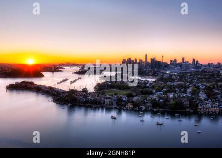 Inner city Inner west suburbs on shores of Parramatta river and Sydney Harbour - aerial sunrise cityscape. Stock Photo