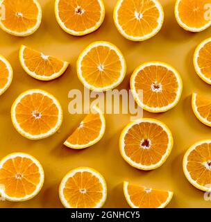 Slices of fresh oranges on orange background.  Stock Photo