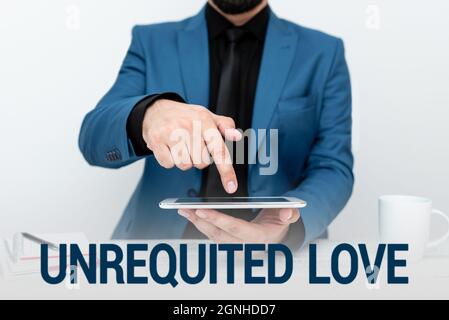 Text sign showing Unrequited Love. Word for not openly reciprocated or understood as such by beloved Presenting Communication Technology Smartphone Stock Photo