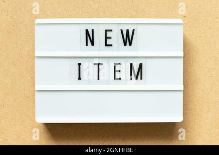 Lightbox with word new item on wood background Stock Photo