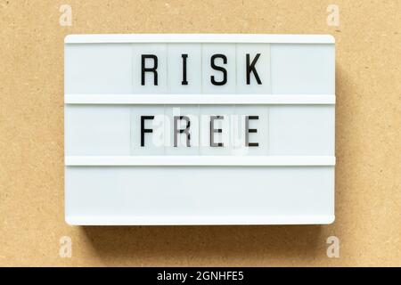 Lightbox with word risk free on wood background Stock Photo