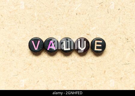 Black color round bead in word value on wood background Stock Photo