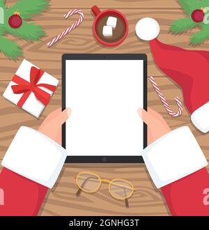 Santa Claus holding tablet with his wooden table in the background - vector flat design illustration. Santa is holding his tablet on wooden desk. Stock Vector