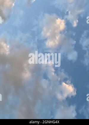 Beautiful sky with clouds illuminated by setting sun Stock Photo