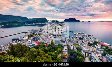 From the bird's eye view of Alesund port town on the west coast of Norway, at the entrance to the Geirangerfjord. Colorful sunset in the Nord. Traveli Stock Photo