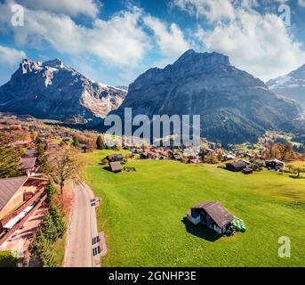 Splendid autumn view of Grindelwald village valley from cableway. Wetterhorn and Wellhorn mountains, located west of Innertkirchen in the Bernese Ober Stock Photo